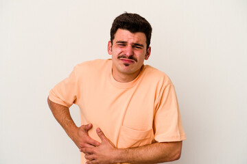 Young caucasian man isolated on white background having a liver pain, stomach ache.