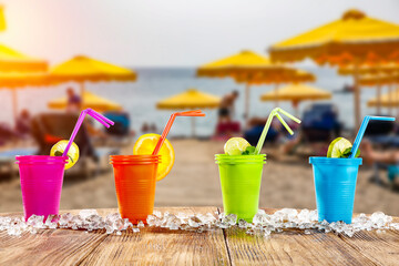 Summer drink on a wooden table on the shore of the ocean on a beautiful sunny day 