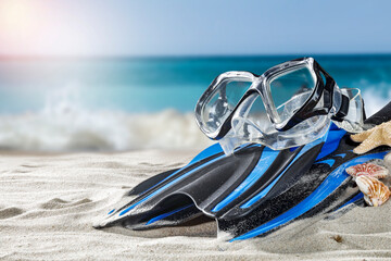 Diving fins on the shore of the blue sea 