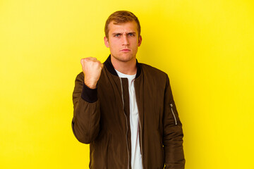 Young caucasian man isolated on yellow background