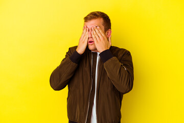 Young caucasian man isolated on yellow background