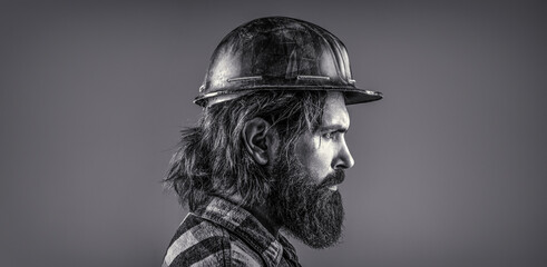 Man builders, industry. Builder in hard hat, foreman or repairman in the helmet. Black and white