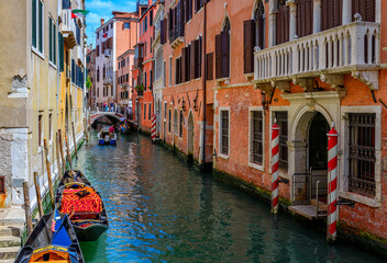 Fototapeta na wymiar Narrow canal with gondola in Venice, Italy. Architecture and landmark of Venice. Cozy cityscape of Venice.