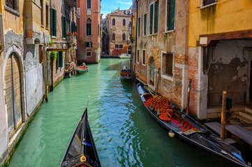 Narrow canal with gondola in Venice, Italy. Architecture and landmark of Venice. Cozy cityscape of Venice.