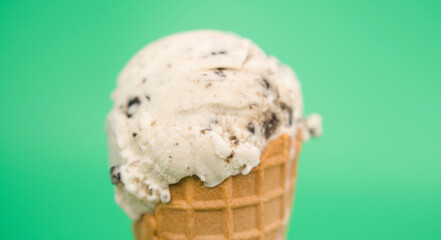 Chocolate Chip in waffle cone isolated on green background, Front view Food concept.