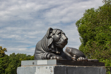 Egyptian sphinx stylized cast-iron sculpture of a lion near pond, Kuzminsky park, Moscow