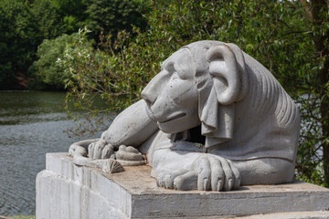Egyptian sphinx stylized cast-iron sculpture of a lion near pond, Kuzminsky park, Moscow