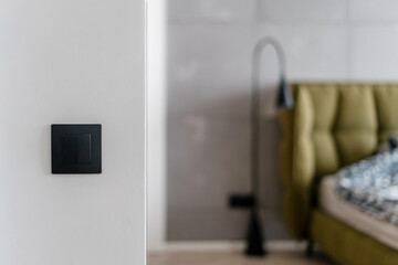 Electrical equipment in modern grey and white bedroom