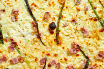 Texture of Delicious pizza with creamy sauce, bacon, onions, melted cheese and crispy sides. Hard light.