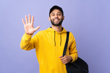 Young sport Moroccan man with sport bag isolated on purple background counting five with fingers