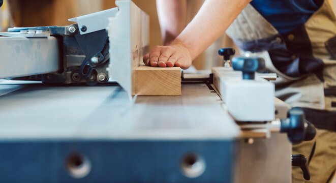 Closeup of carpenter at circular cutter
