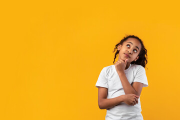 Pensive black girl looking up aside at free copy space - Powered by Adobe
