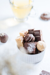 Combination of  sweet bites on a bright background with cup of tea