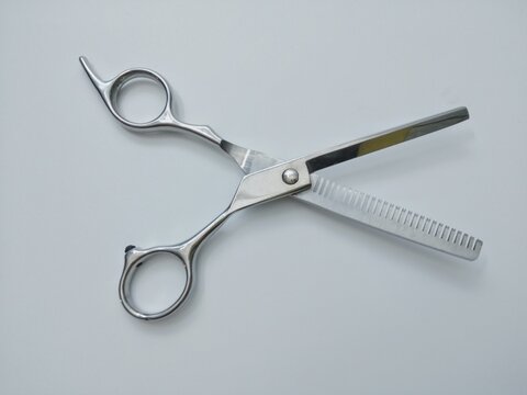Stainless steel scissors on a white background give the hairdresser hair clipper concept.