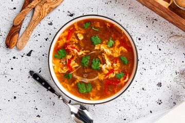 Bowl of spicy beef soup on a light decorated background