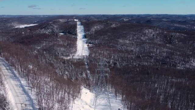 Documentary on modern telecommunication towers with satellites and antennas attached to them, and connected with wires shown in this aerial shot.
