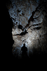cave speleologists in the meanders of the earth. rock, stalactites and stalagmites