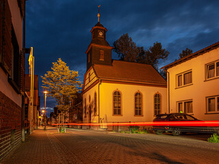 Fototapeta na wymiar View of the historic protestant church of Walldorf in hesse during sunset