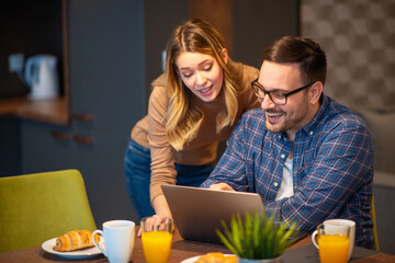 Excited young couple shopping online