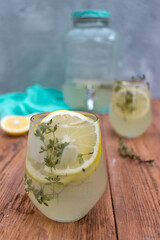 Lemon drink with lemon slices on a wooden background