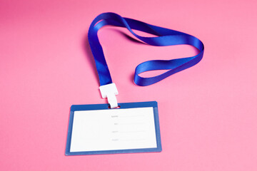 employee ID tag on pink background