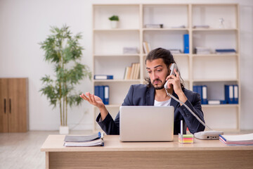 Young male employee working in the office