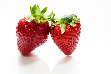 two strawberries on a white background