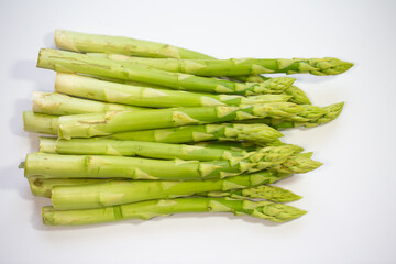 green asparagus on pink background, vegetables