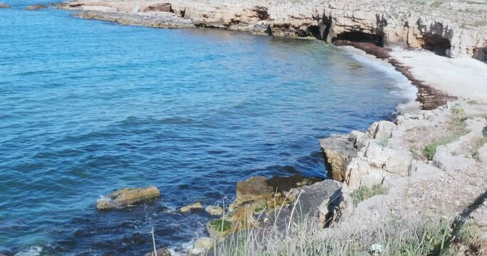 View of the coast of Bisceglie, near Bari. Cliff overhanging the sea caves of Ripalta
