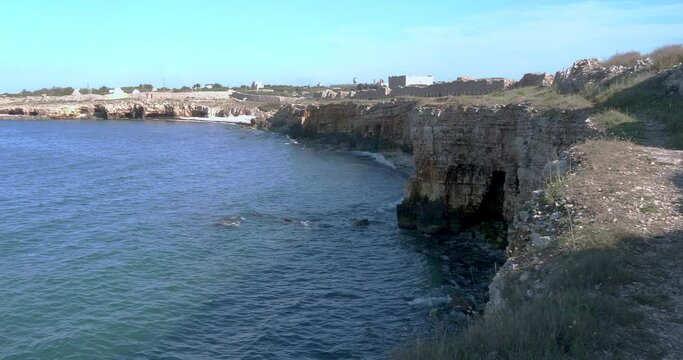View of the coast of Bisceglie, near Bari. Cliff overhanging the sea caves of Ripalta