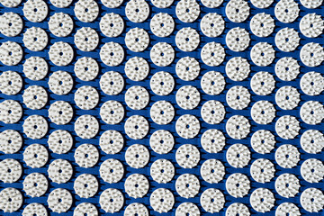 Top view of blue acupressure prana mat for home acupuncture massage, backdrop of blue mattress with...