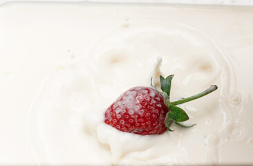 red ripe strawberries and white cream. homemade yogurt.