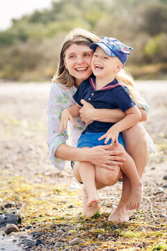 Happy Mother and son have a rasting at the beach