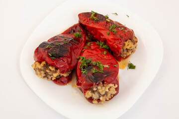 Red peppers stuffed with meat and rice. Filled peppers in white plate