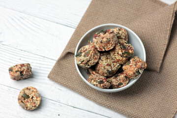 Healthy eating concept - a bowl of crunchy on white wooden background flat lay