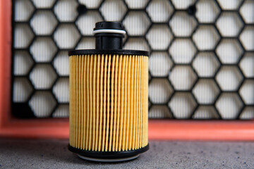 car oil filter on the background of the air filter