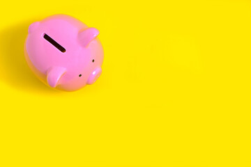Naklejka premium Pink Piggy Bank on Yellow Background