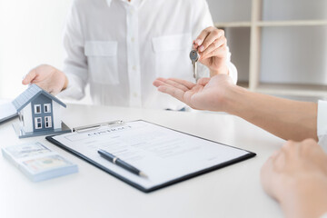 Property investment concept, image of small house model on the table. and home loan insurance. 