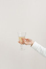 faceted glass glass in the hands of a girl in white clothes glass