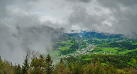 Top mountain view from Kneifelspitze to the City of Berchtesgaden with huge rain clouds at the background