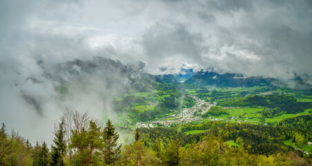 Top mountain view from Kneifelspitze to the City of Berchtesgaden with huge rain clouds at the background