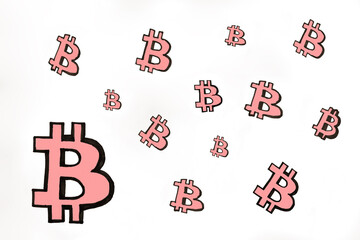 Photo of the Pink hand drawn Bitcoin icons of different sizes on white paper. bitcoin cryptocurrency market. Investments in e-currency concept.