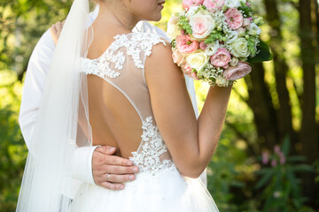 bride holding bouquet from side