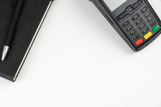 POS terminal or credit card reader machine on the white table with copy space. 