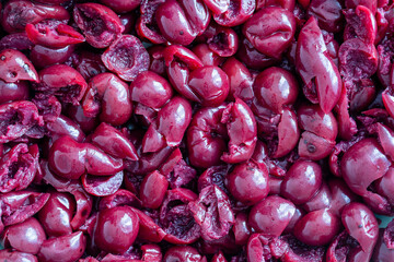 Pitted cherry in alcohol in their own juice in a plate, close up, top view