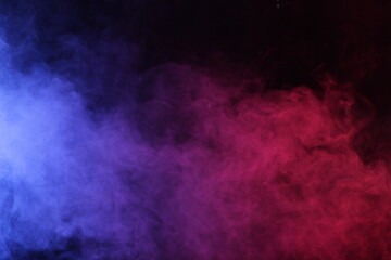 Artifiacial magic smoke in red-blue light on black background