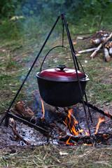 A pot over the fire. Summer vacation, hike, tourism - 436735354