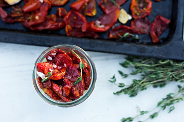 sun-dried tomatoes. Sun-dried tomatoes with herbs and garlic on a wooden background. - 436735710
