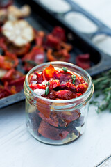 sun-dried tomatoes. Sun-dried tomatoes with herbs and garlic on a wooden background. - 436735740