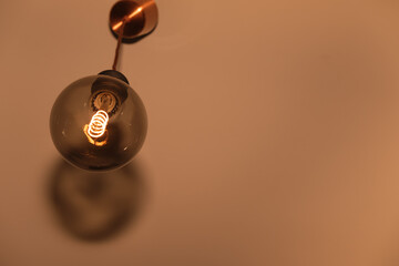 Horizontal picture with a retro light bulb switched on and glowing